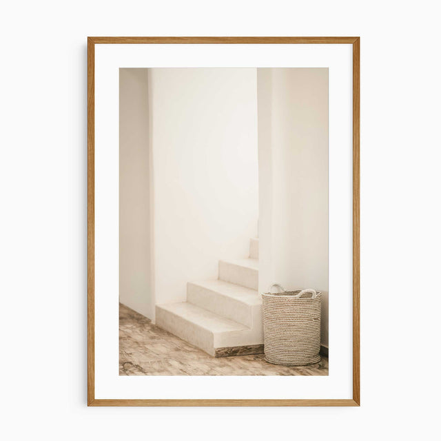 Soft-toned neutral wall print of staircase and woven basket