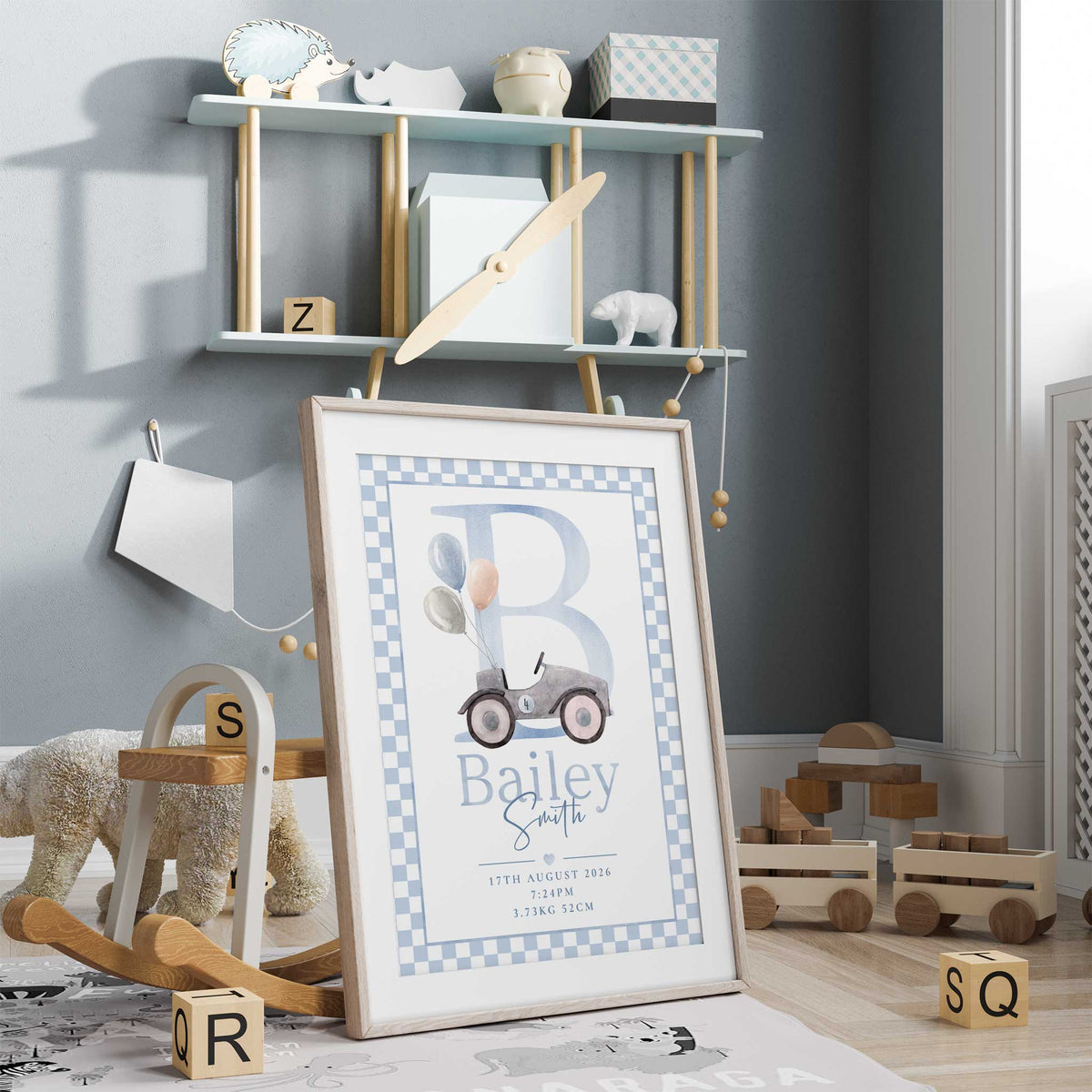 Vintage car nursery print with pastel balloons, a large blue initial, personalised name and birth details within a checked border.