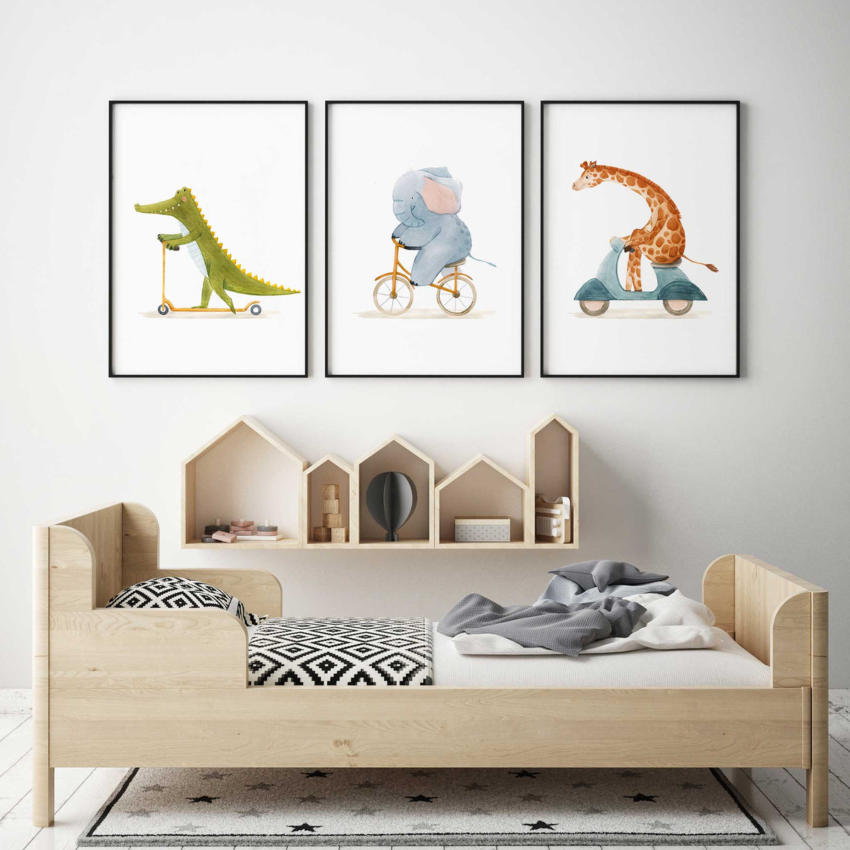 Watercolour animal wall art set of three with a crocodile and giraffe riding scooters and an elephant riding a bicycle.
