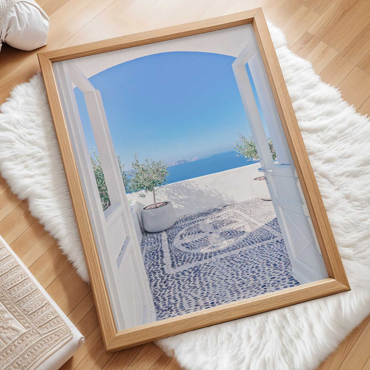 A serene Greek island patio with a stunning ocean view, white archway, pebble mosaic flooring, and potted olive trees, capturing the beauty of Santorini.