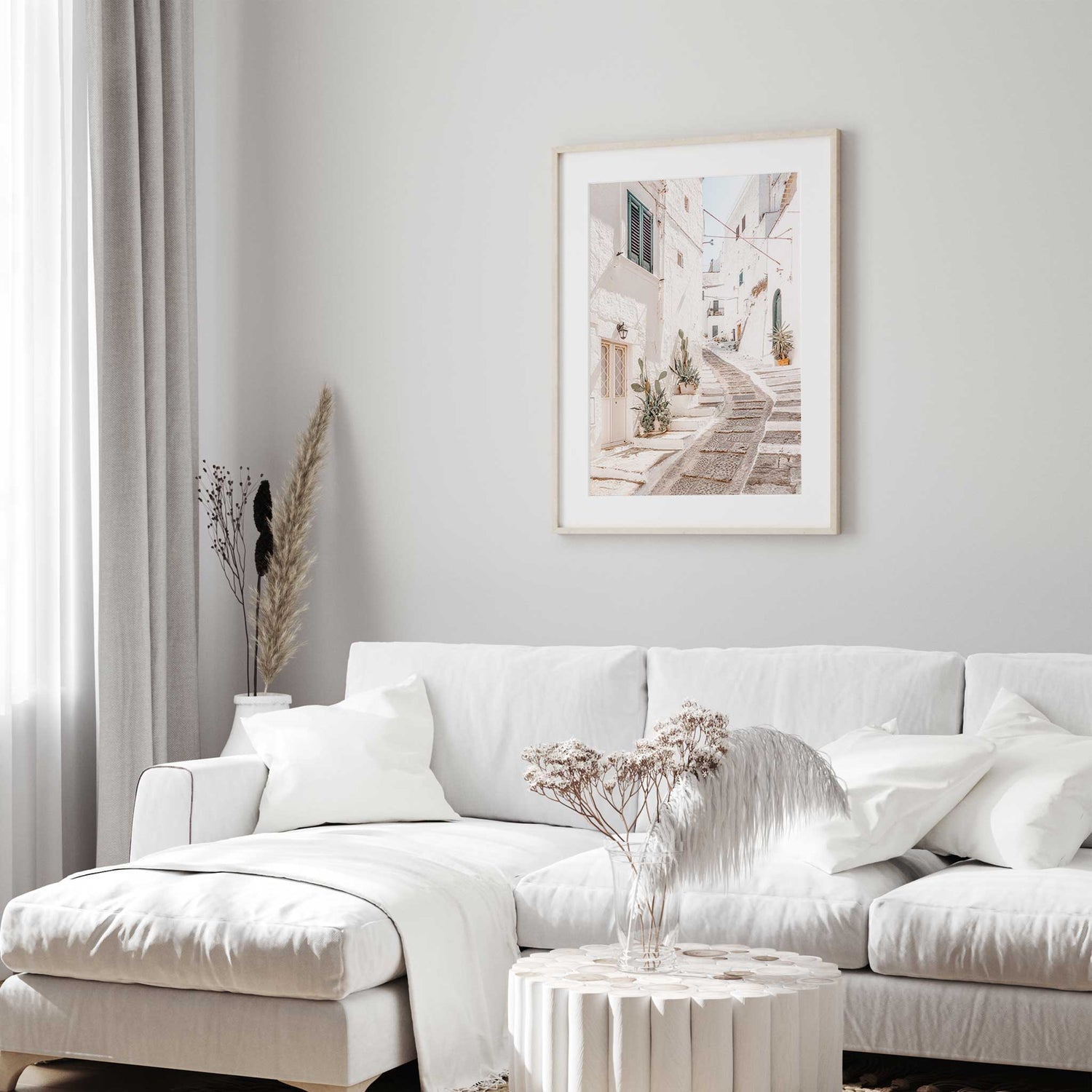 Modern wall decor of Mediterranean whitewashed buildings and greenery.