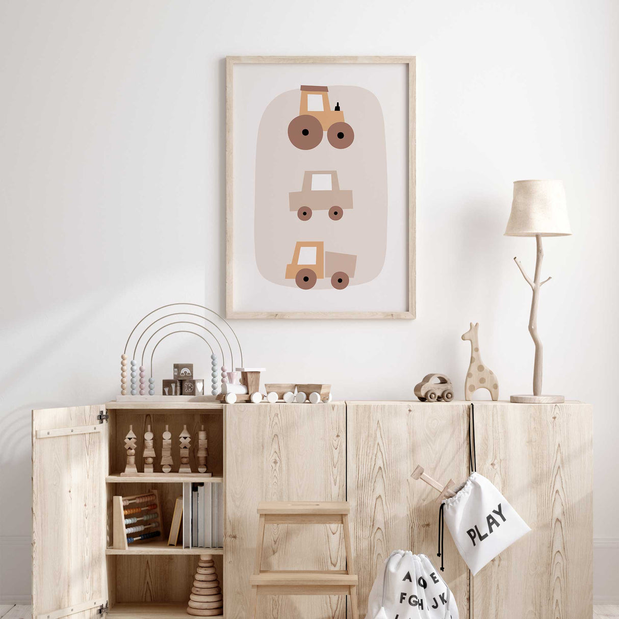 Baby room decor print with a simple design of a tractor, car, and truck.
