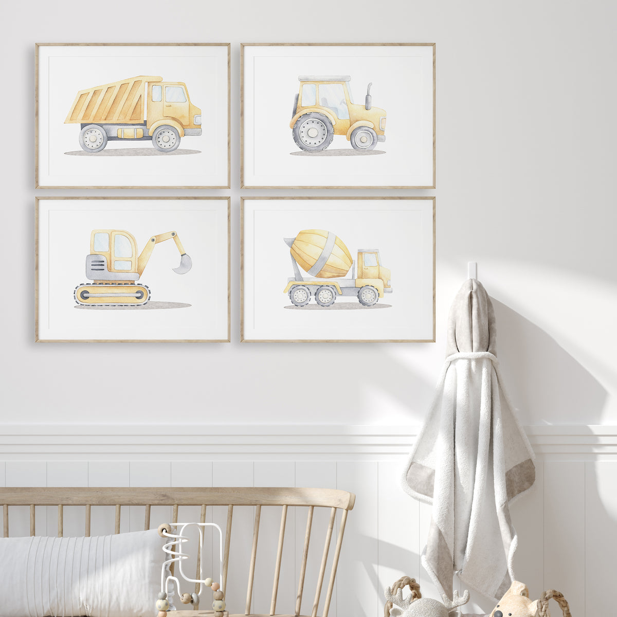 Yellow construction vehicle prints set of four showing a dump truck, tractor, excavator and cement mixer on white.
