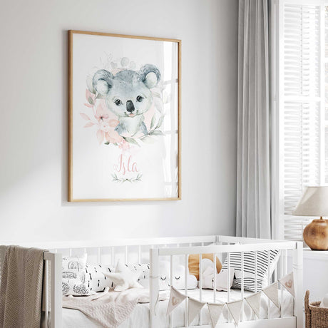 Floral koala name print in pink script beneath a grey watercolour koala with pink flowers and leaves.