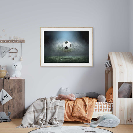 Striking soccer wall art print showcasing a football bursting through mist and turf, ideal for sports-themed decor."
