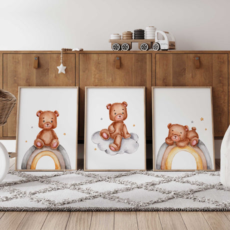 Set of three teddy bear nursery prints featuring watercolour teddy bears sitting on rainbows and clouds in soft neutral tones for a calming baby nursery or kids bedroom wall art display