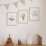 Three blue nursery prints showing an aeroplane, hot air balloon and helicopter with coordinating cloud details