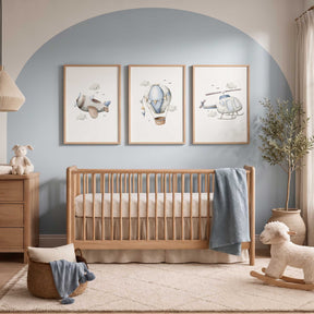Set of three blue airplane nursery prints featuring an aeroplane, hot air balloon and helicopter for a boys bedroom.