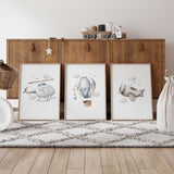 Set of three airplane nursery prints featuring a blue helicopter, hot air balloon and aeroplane with clouds