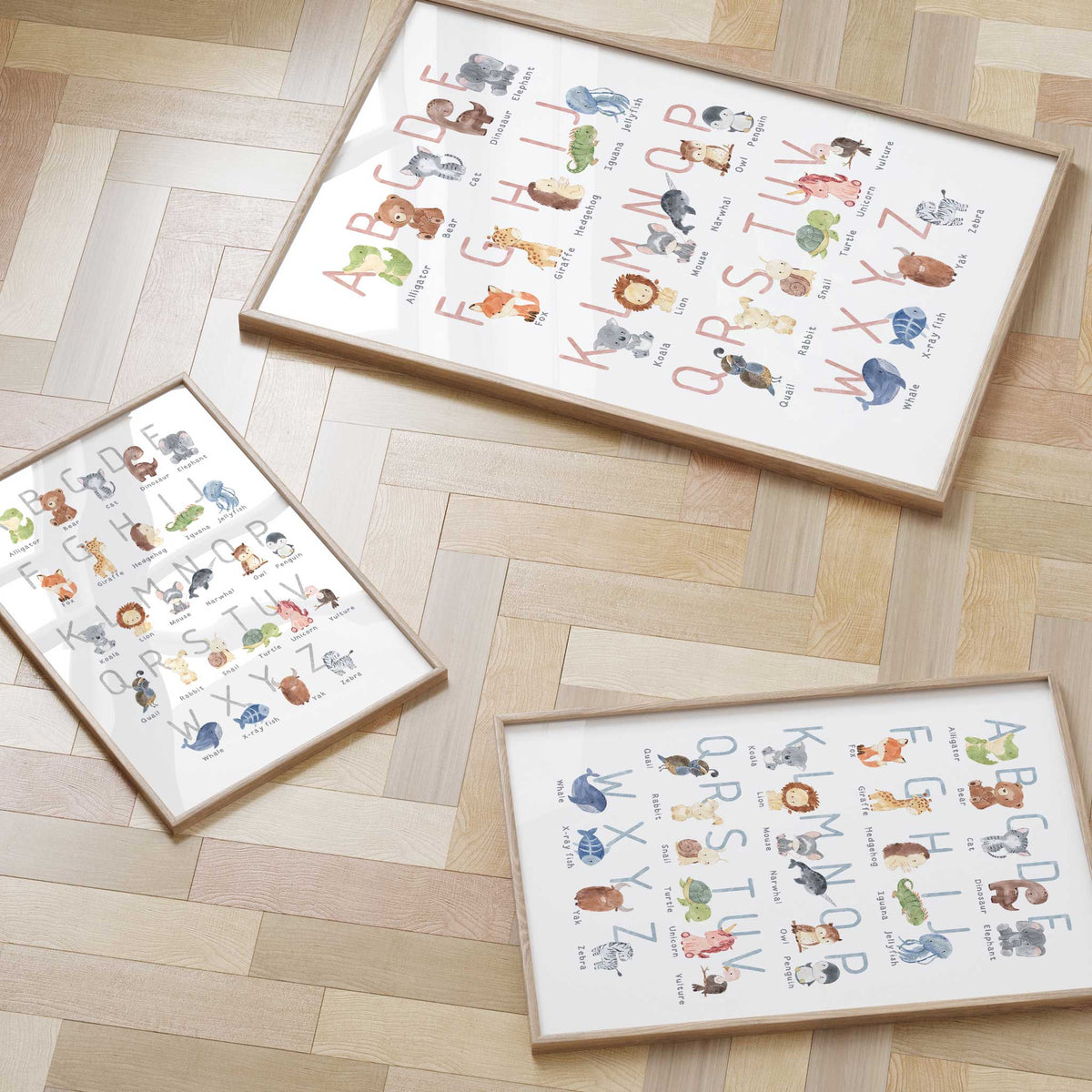 Animal alphabet print shown in pink, blue and grey letter options, with watercolour illustrations and animal names.