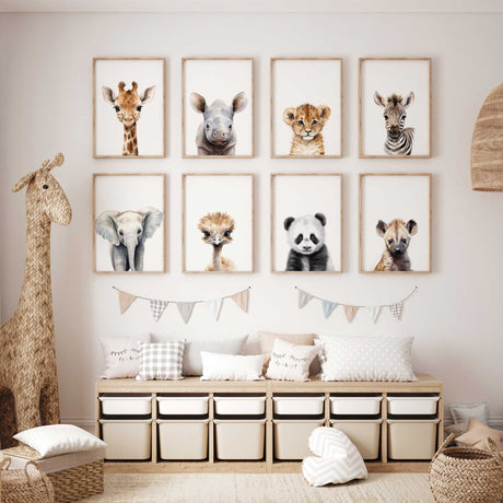 Eight baby animal portraits featuring giraffe, rhino, lion, zebra, elephant, ostrich, panda and hyena on white.