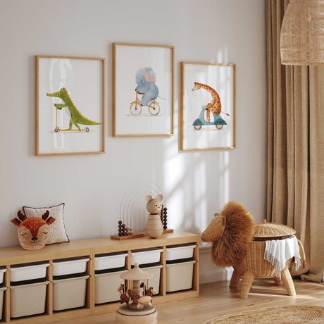 Three watercolour animal nursery prints showing a crocodile on a scooter, elephant on a bicycle and giraffe on a scooter.