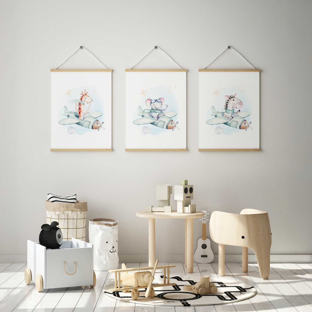 Three animal aeroplane prints featuring a giraffe, elephant and zebra in pale mint planes with clouds and star details.