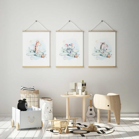 Three animal aeroplane prints featuring a giraffe, elephant and zebra in pale mint planes with clouds and star details.