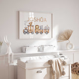 Animal train nursery name print above a giraffe, lion, hippo and elephant riding in brown train carriages.