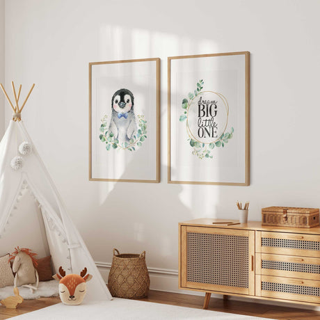 Baby boy nursery wall art set featuring penguin print and Dream Big Little One quote with greenery