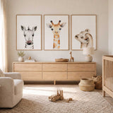 Three safari nursery prints showing a baby lion, giraffe and zebra in soft watercolour with clean white backgrounds.