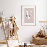 A minimalist design featuring an initial letter  with a name elegantly written over it in cursive. suitable for nursery or bedroom decor