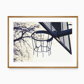 minimalist basketball hoop wall art with chain net and neutral sky background