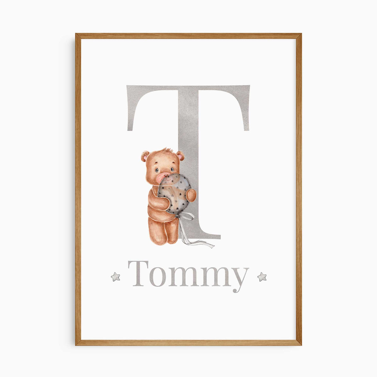 Grey T initial and Tommy name print with a watercolour bear holding a star-patterned balloon on a white background.
