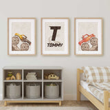 Yellow and red monster truck prints with muddy tyres and a personalised initial print on pale beige backgrounds.