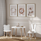 Beige safari nursery wall art set of three featuring a lion, zebra and elephant in soft neutral tones.