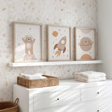 Kids space wall art set with rocket, bear astronaut and planet illustrations in warm neutral colours for nursery decor