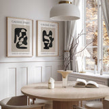 Pair of black and beige abstract prints with flowing shapes, cream margins and matching French gallery lettering.