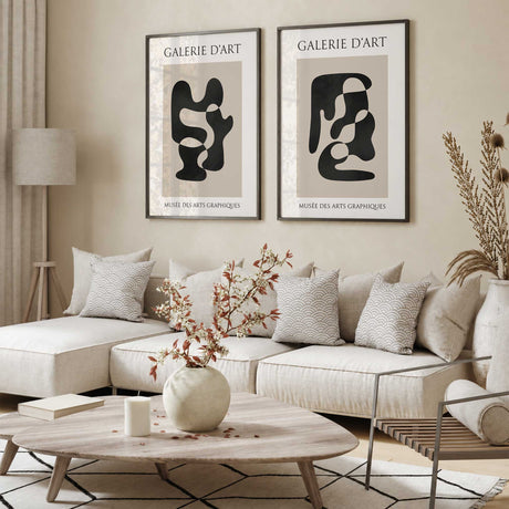 Set of two black and beige abstract prints with flowing organic shapes, cream margins and French gallery lettering.