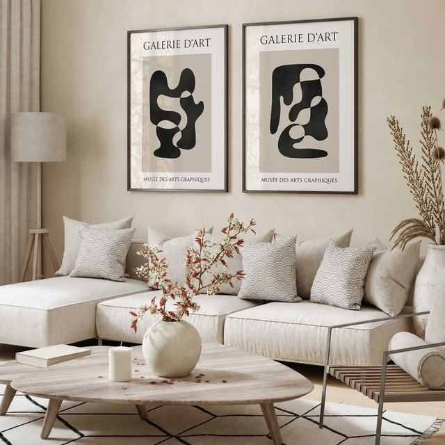 Set of two black and beige abstract prints with flowing organic shapes, cream margins and French gallery lettering.