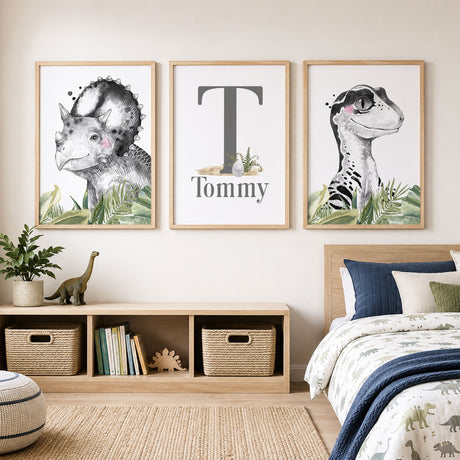 Personalised dinosaur wall art set with name and initial, black and white portraits and green leaves 