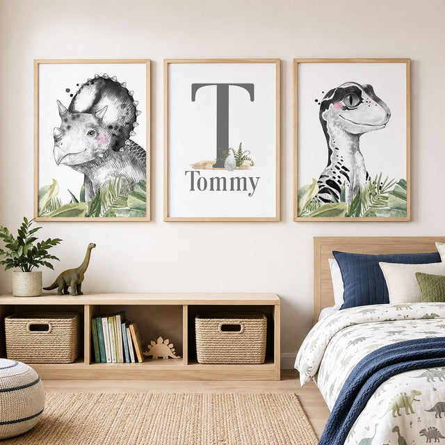 Personalised dinosaur wall art set with name and initial, black and white portraits and green leaves 