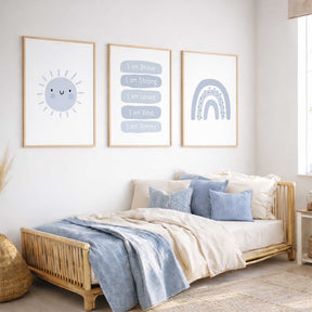 Personalised blue affirmation print set featuring a smiling sun, dotted rainbow and white lettering on rounded blue panels.
