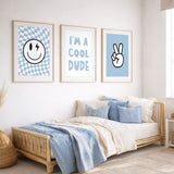 Blue boys wall art set featuring smiley face with lightning eye, “I’m a cool dude” typography print, and peace sign hand illustration in soft blue tones for kids bedroom or nursery.