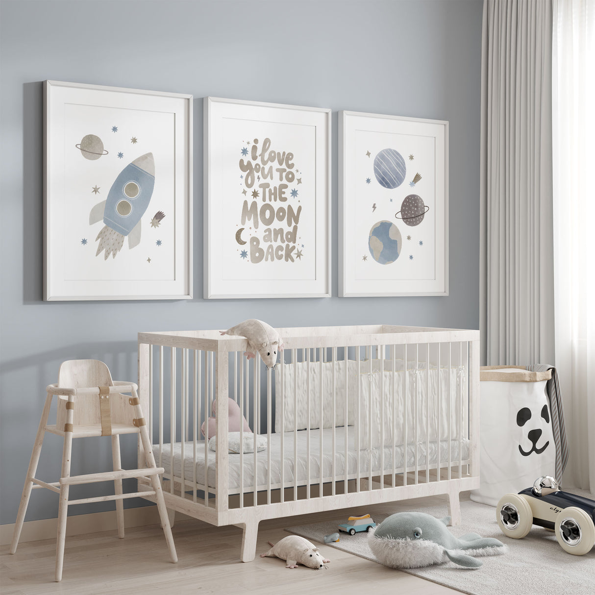Blue space nursery wall art set featuring a rocket, planets and moon quote prints in soft neutral tones for boys bedroom decor