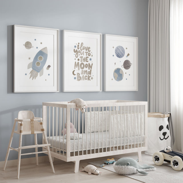 Blue space nursery wall art set featuring a rocket, planets and moon quote prints in soft neutral tones for boys bedroom decor