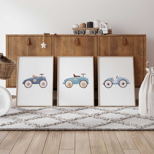 Three vintage toy car prints in muted blue tones, with watercolour ride-on cars numbered 1 to 3 on white backgrounds.