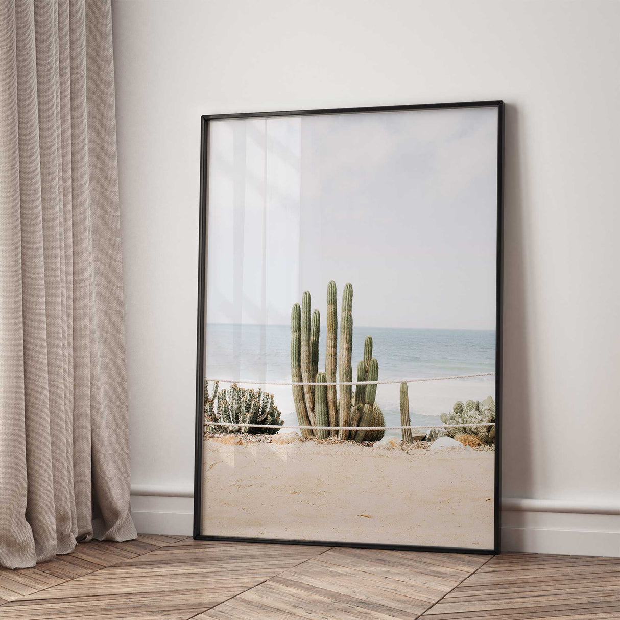 Boho coastal wall art showing cactus plants in sandy beach setting