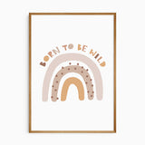 Born to Be Wild rainbow print with beige, tan and ochre arches, brown spots and curved lettering on a pale background.
