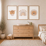 Set of three safari nursery prints with a spotted giraffe, lion face and Born to Be Wild rainbow in warm neutral tones.