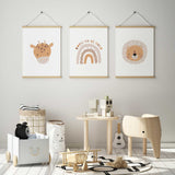 Safari print trio with a spotted giraffe, a lion with a circular mane and a Born to Be Wild rainbow on pale backgrounds.