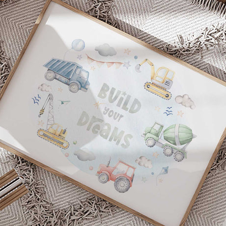 Construction vehicle print for a boys bedroom featuring soft blue yellow green and red trucks with Build Your Dreams text