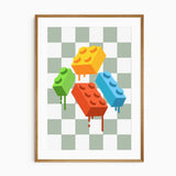 Four colorful building bricks dripping paint, set against a green and white checkerboard background