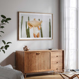 Cactus and sunhat photography print with a white border, showing a woman in an ivory swimsuit.
