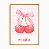 Cherry bow wall art featuring two red cherries tied with a pink ribbon, soft pink gingham background and ma chérie text.