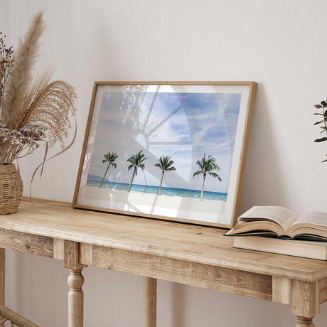 Coastal beach photography print with palm trees, pale sand and turquoise water for a relaxed beach house look.