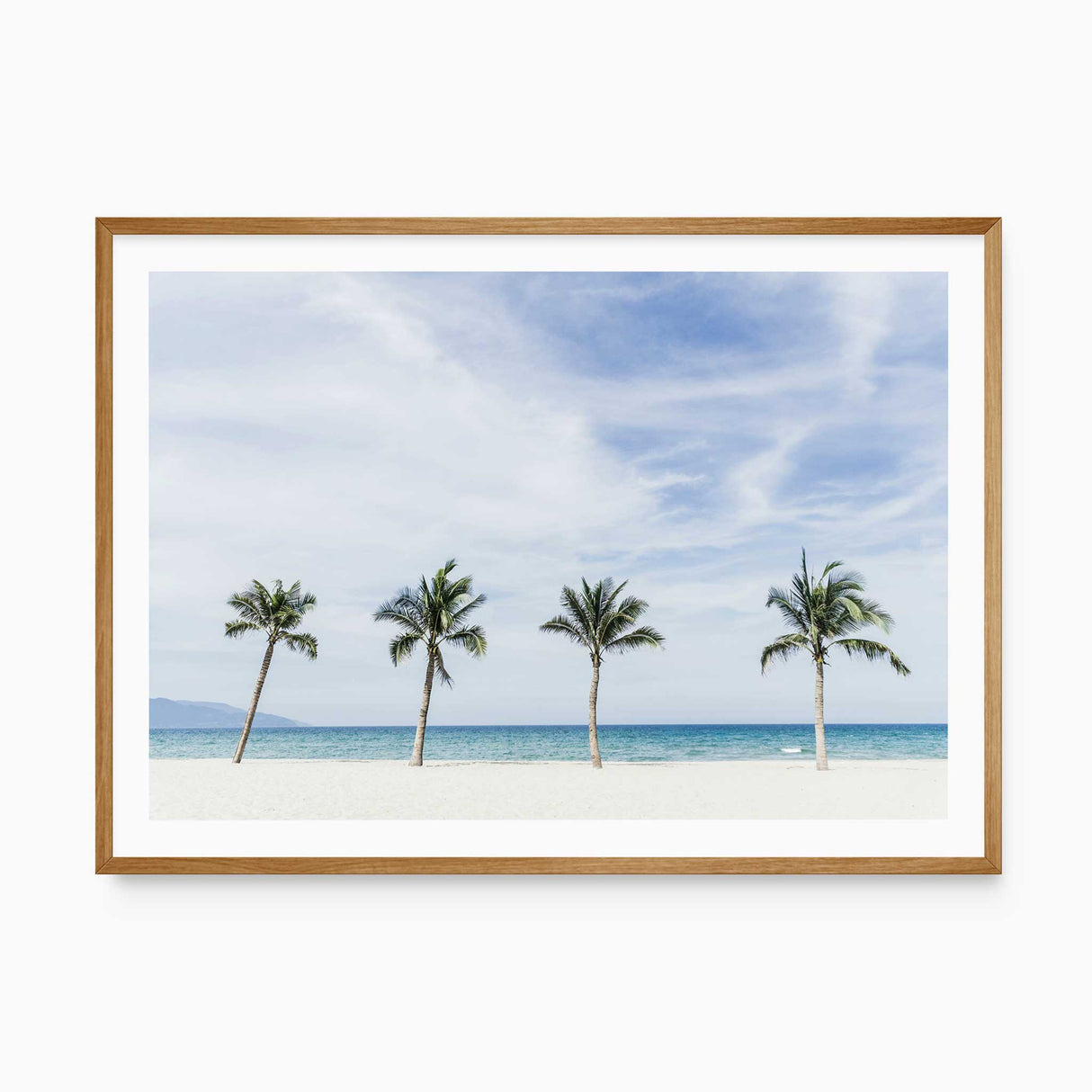 Coastal beach wall art featuring palm trees, white sand and turquoise ocean for a light relaxed coastal home.