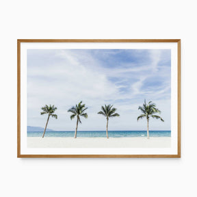 Coastal beach wall art featuring palm trees, white sand and turquoise ocean for a light relaxed coastal home.