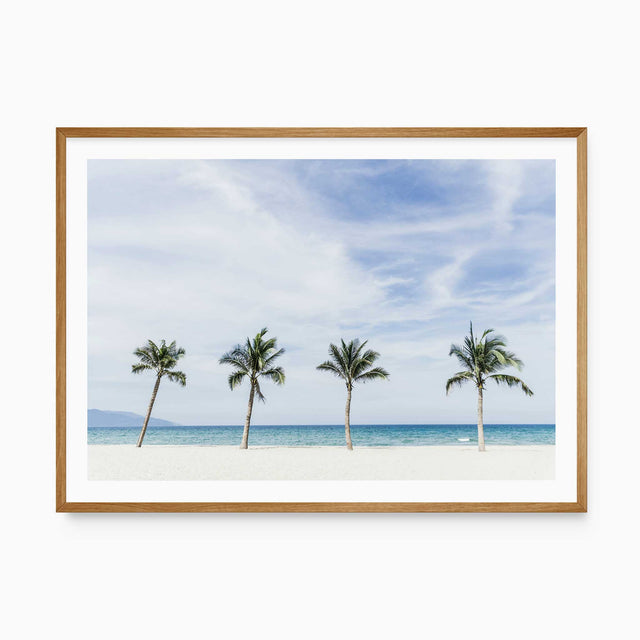 Coastal beach wall art featuring palm trees, white sand and turquoise ocean for a light relaxed coastal home.