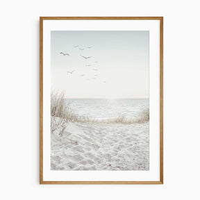 Coastal wall art print with sandy dunes and ocean view under a soft sky.